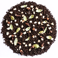 A circular pile of dark chocolate-flavored coffee mix or cocoa powder, featuring whole coffee beans, green cardamom pods, cinnamon sticks, and small white chunks, photographed from directly above on a white background.