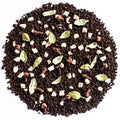 A circular pile of dark brown coffee grounds mixed with whole spices including cardamom pods, cloves, cinnamon sticks, and cubed white sugar, photographed from directly above on a white background.