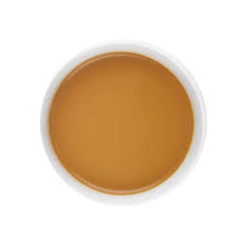 A circular, top-down view of a smooth, warm brown cosmetic cream or gel inside a white circular container, isolated on a white background.