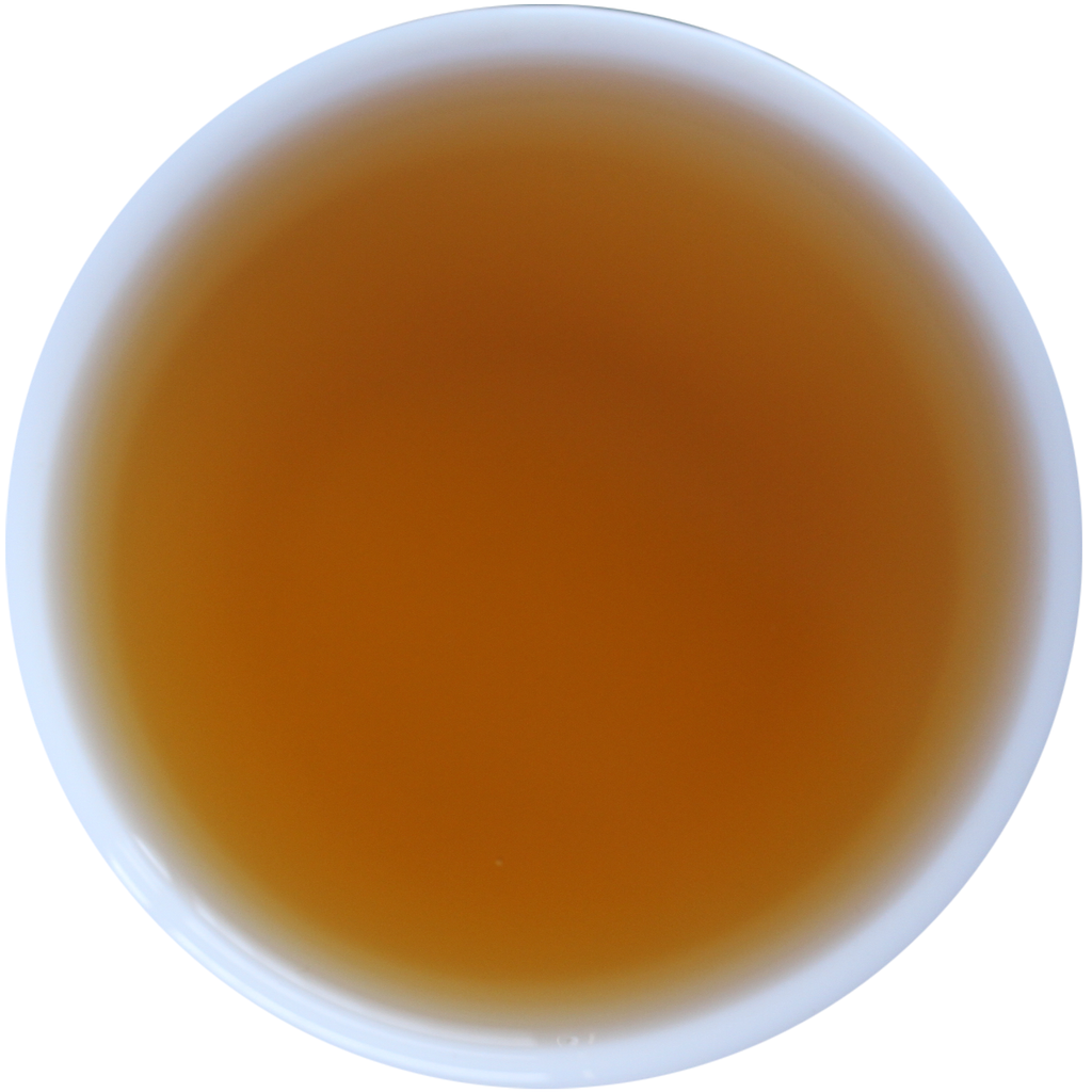 A top-down view of a white cup filled with amber-brown liquid, likely tea, against a plain white background.