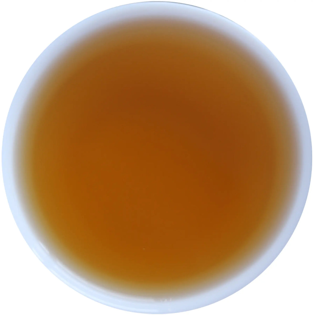 A top-down view of a white cup filled with a translucent amber-brown liquid, isolated on a white background.