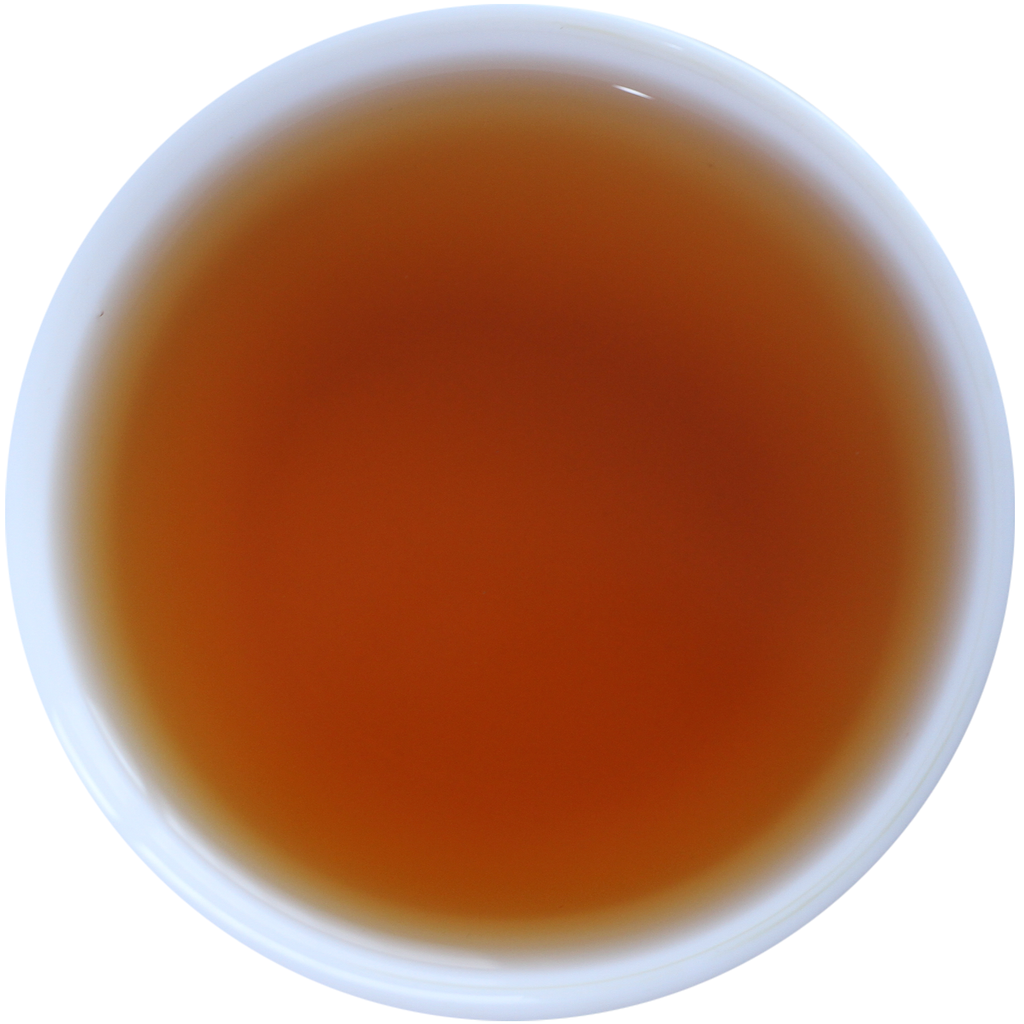 A top-down view of a white cup filled with a translucent amber-brown liquid, likely tea or wine, isolated on a white background.