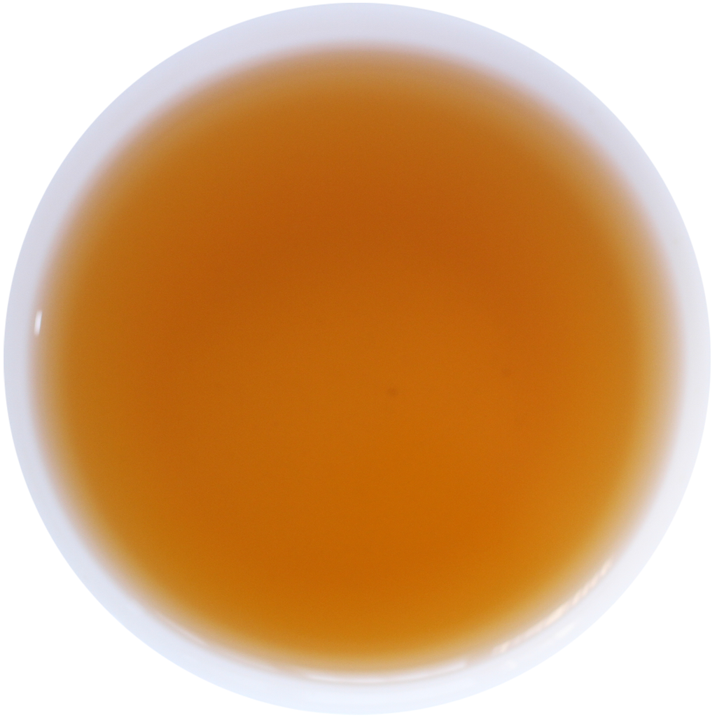A top-down view of a white cup filled with a translucent amber-orange liquid, isolated on a white background.