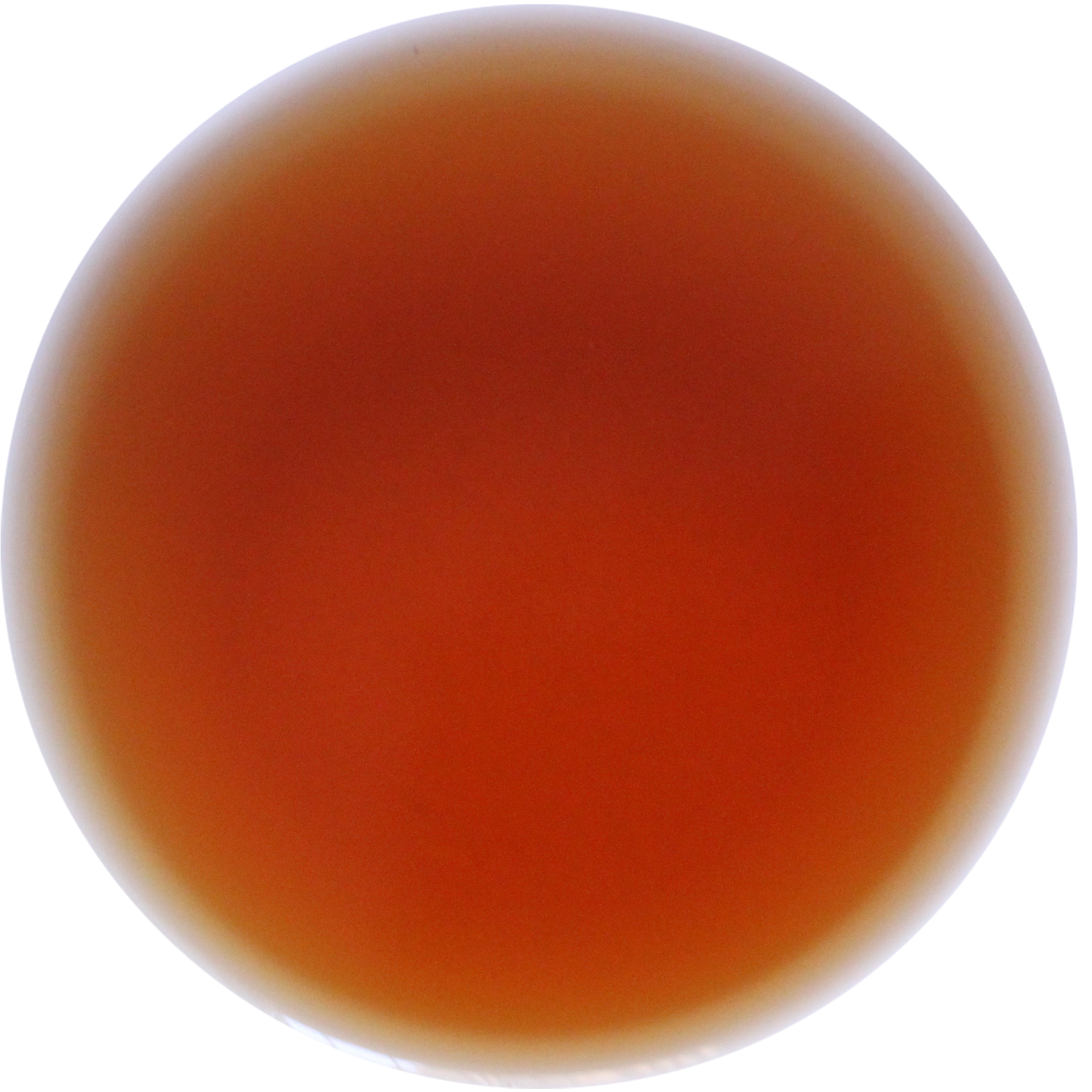 A circular color swatch showing a warm, translucent amber-brown hue with soft white highlights on a plain white background.