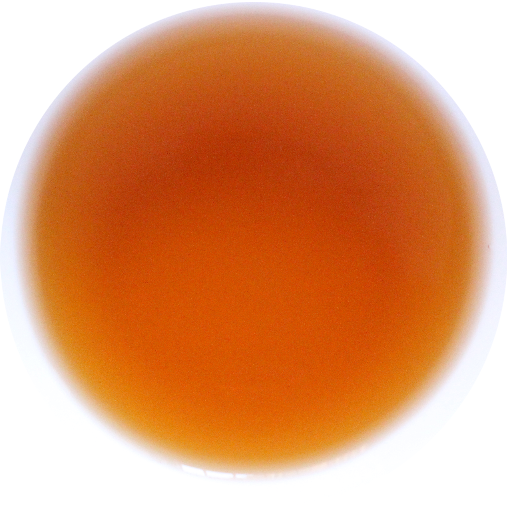 A circular color swatch showing a warm amber-orange translucent hue on a white background.