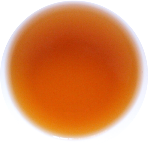A circular color swatch showing a warm amber-orange translucent hue on a white background.