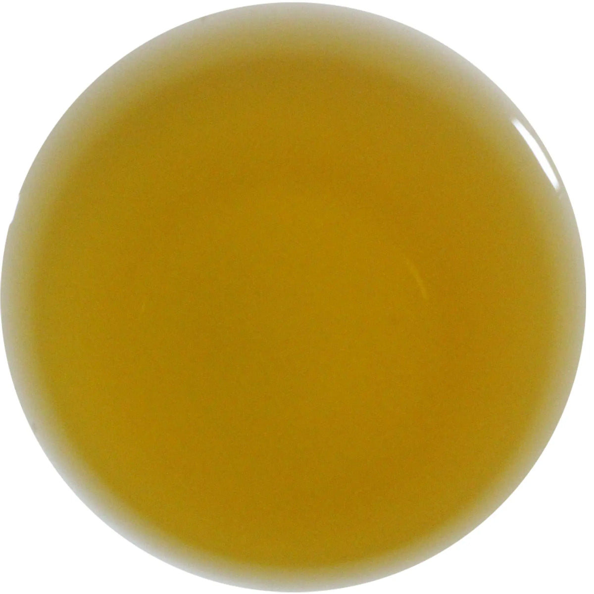 A smooth, glossy circular swatch of translucent ochre yellow gel or liquid on a solid white background.