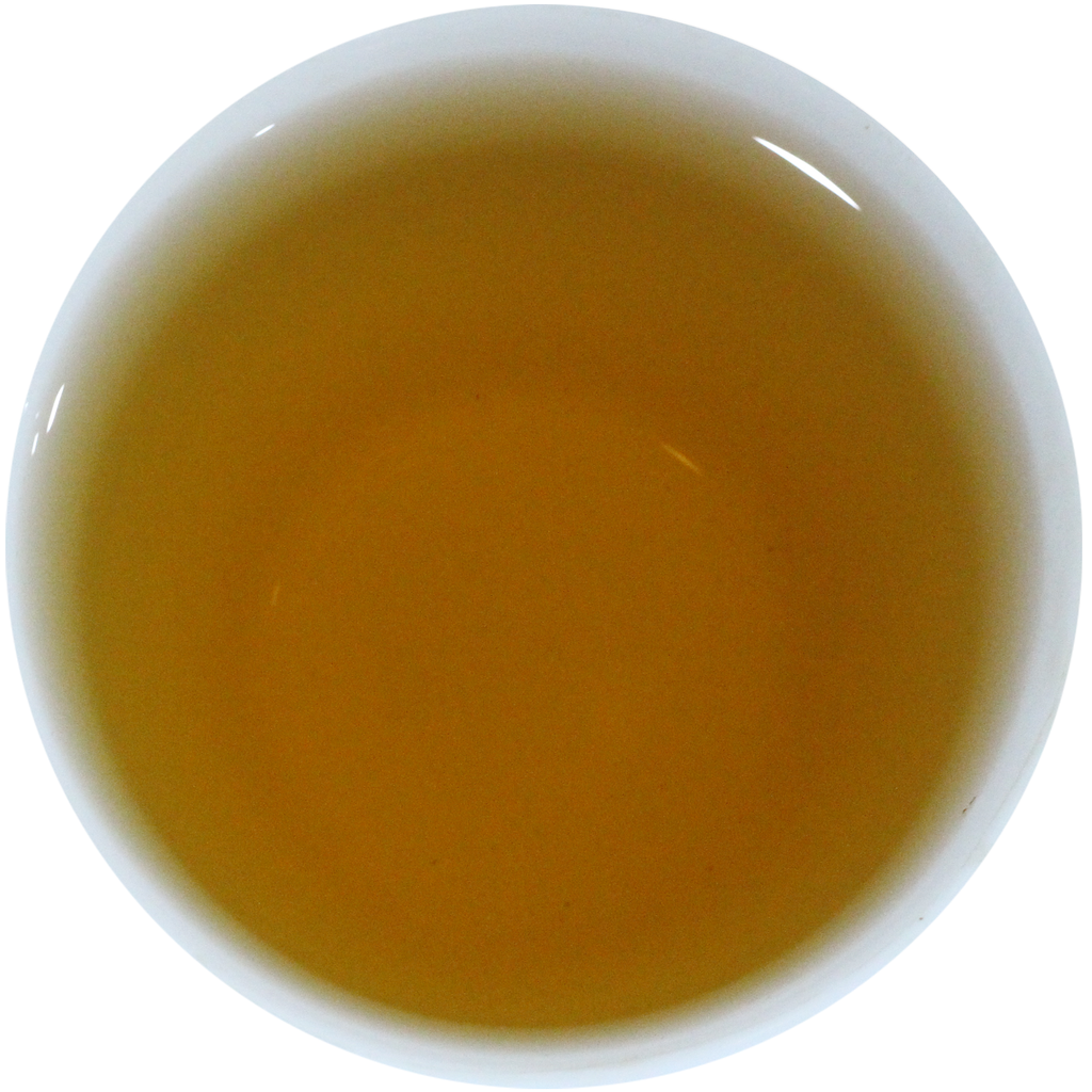A top-down view of a white ceramic cup filled with a translucent amber-gold liquid, likely tea, on a plain white background.