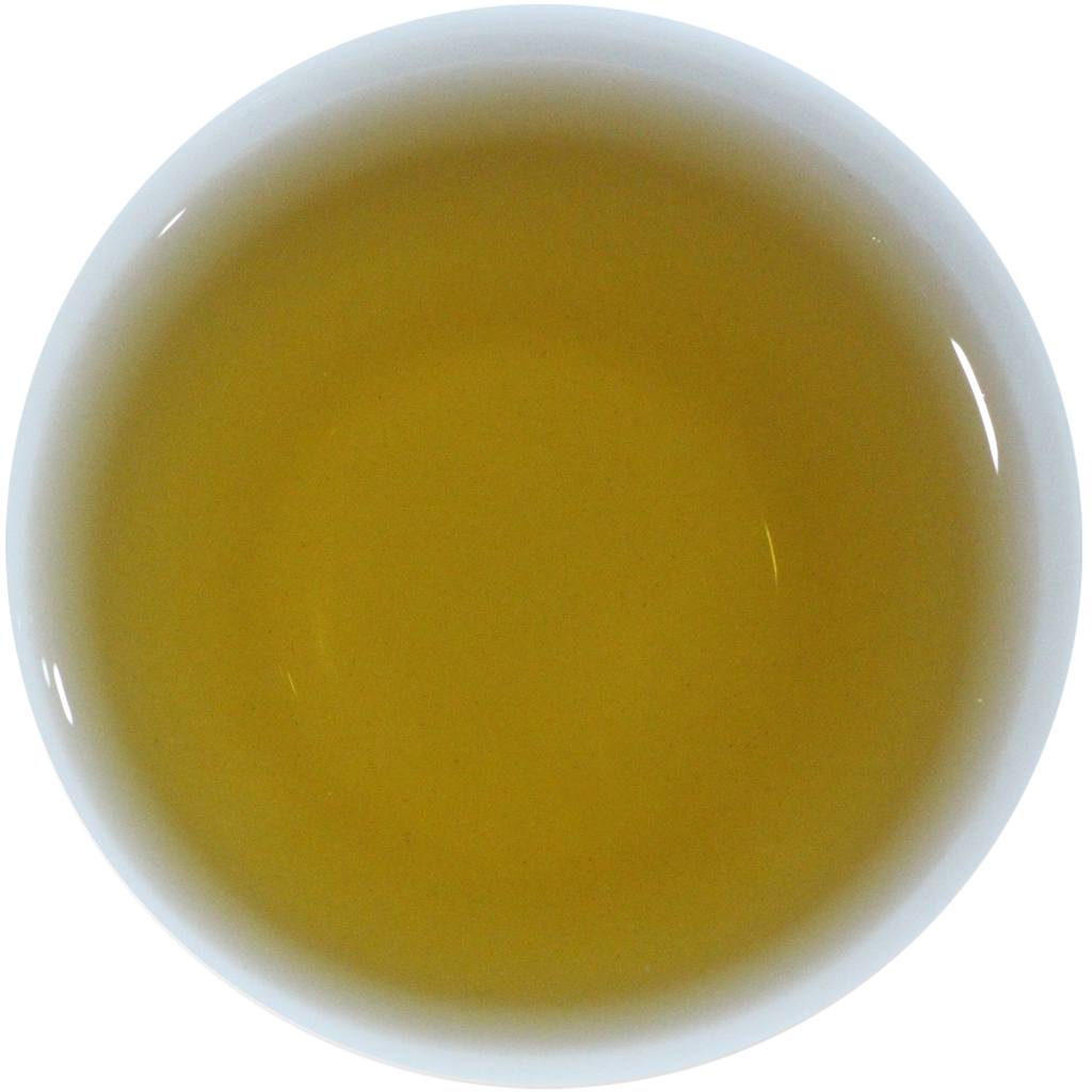 A top-down view of a white cup filled with a translucent golden-yellow liquid, likely tea, on a plain white background.