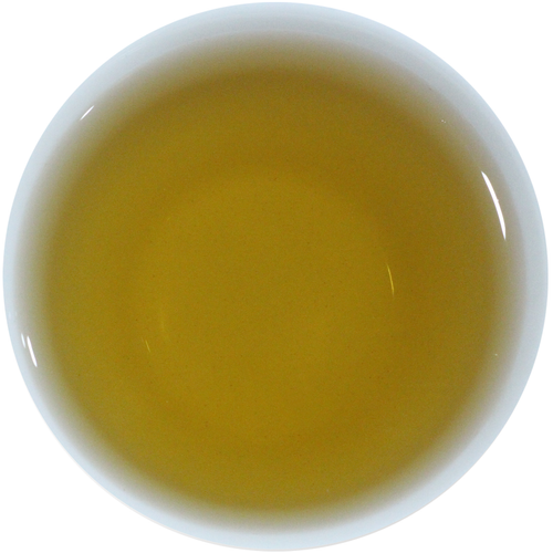 A top-down view of a white cup filled with a translucent golden-yellow liquid, likely tea, on a plain white background.