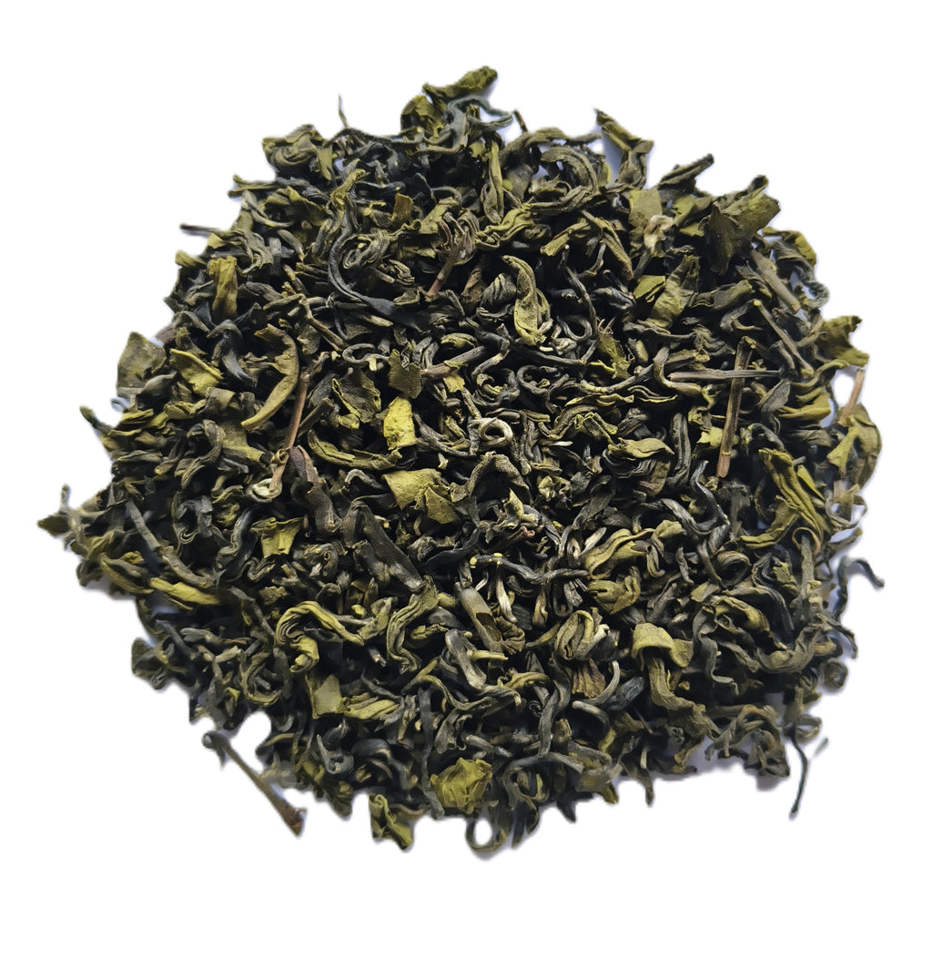 A pile of loose-leaf green tea leaves, showing their curly, dried texture, isolated on a white background.