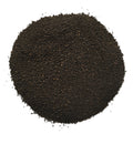 A mound of dark brown to near-black granular powder or fine solid material, photographed from above on a plain white background.