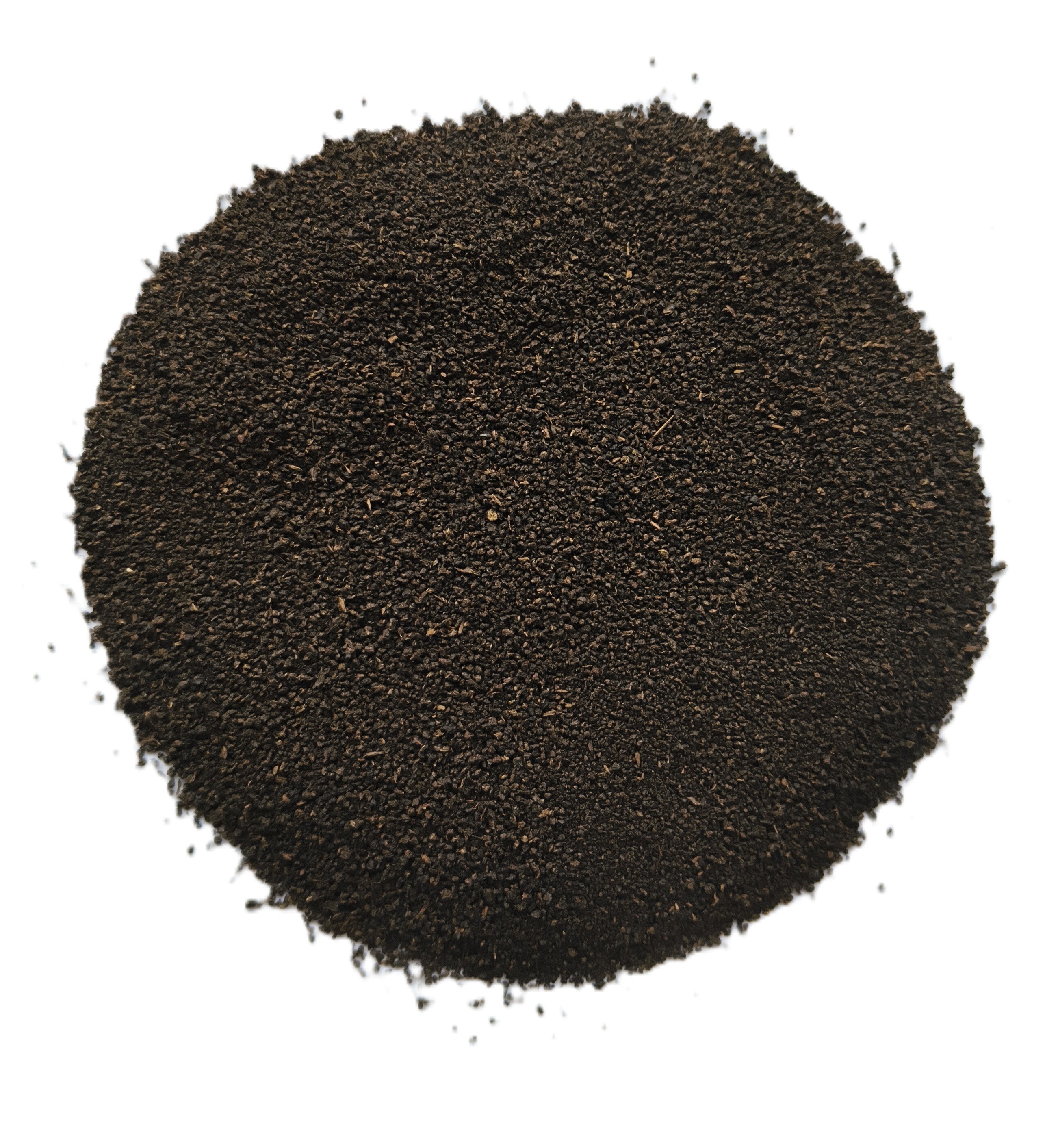 A mound of dark brown to near-black granular powder or fine solid material, photographed from above on a plain white background.