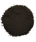 A pile of dark brown to black granular powder or substrate material, photographed from directly above on a plain white background.