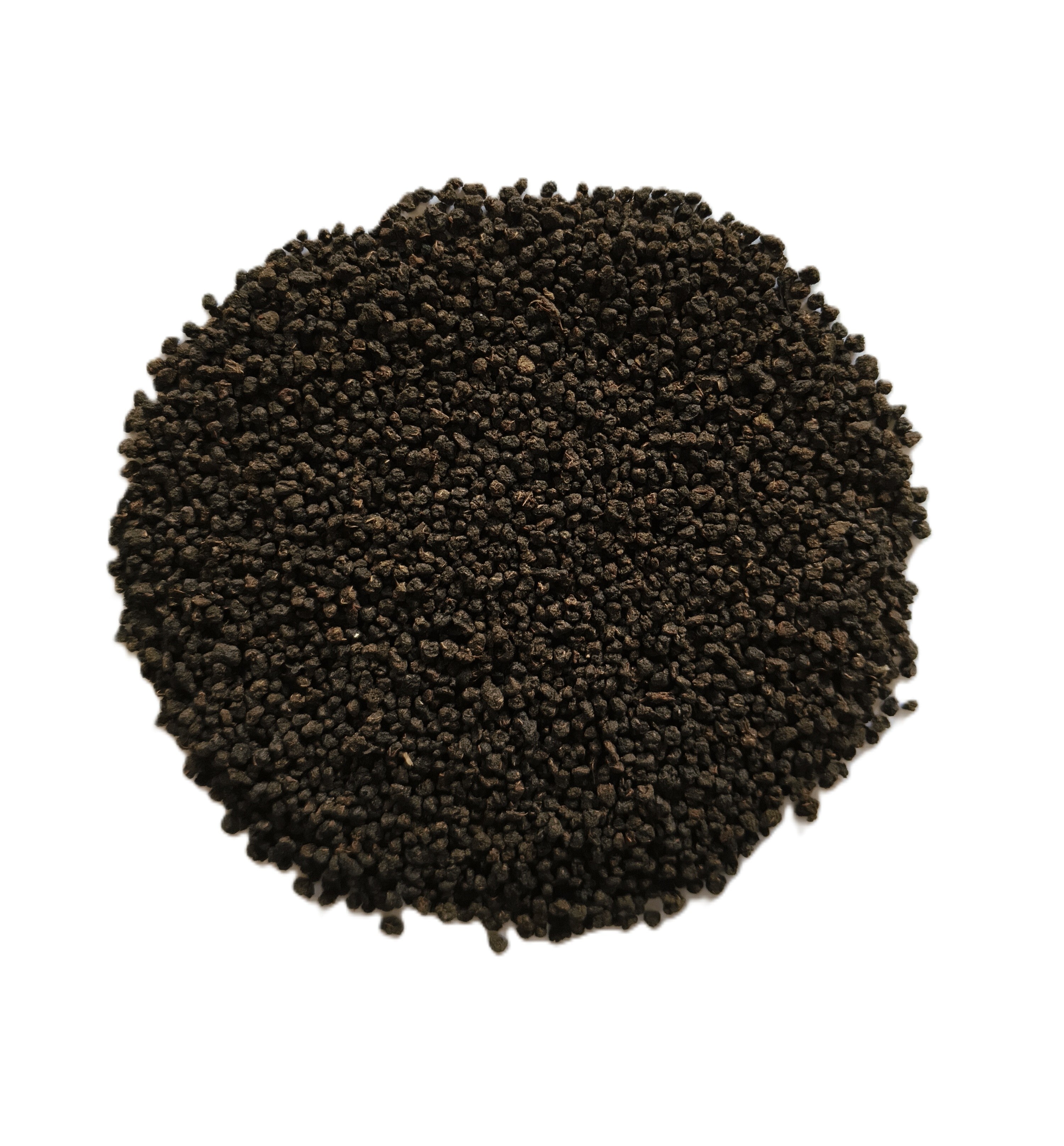 A circular pile of small dark brown to black seeds or grains on a plain white background.