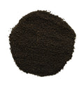 A pile of dark brown to black coarse sand or gravel, photographed from directly above on a solid white background.