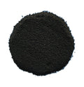 A pile of dark black granular powder or substrate material, photographed from directly above on a solid white background.