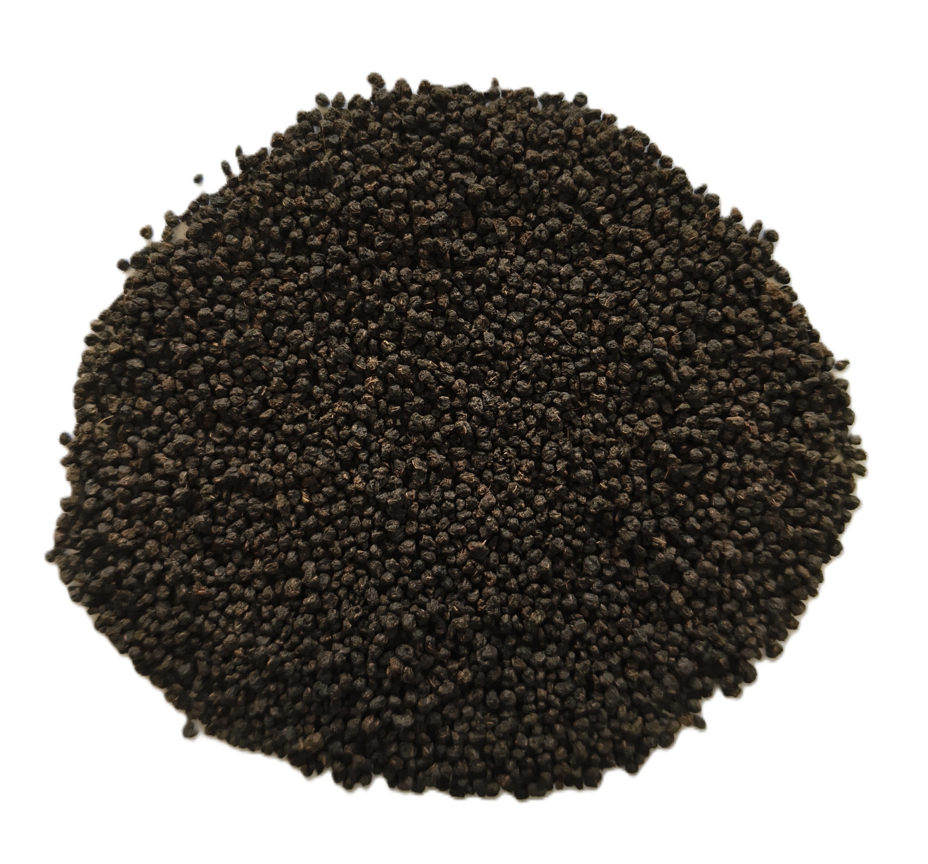 A pile of small dark brown to black seeds or grains photographed from above on a plain white background.