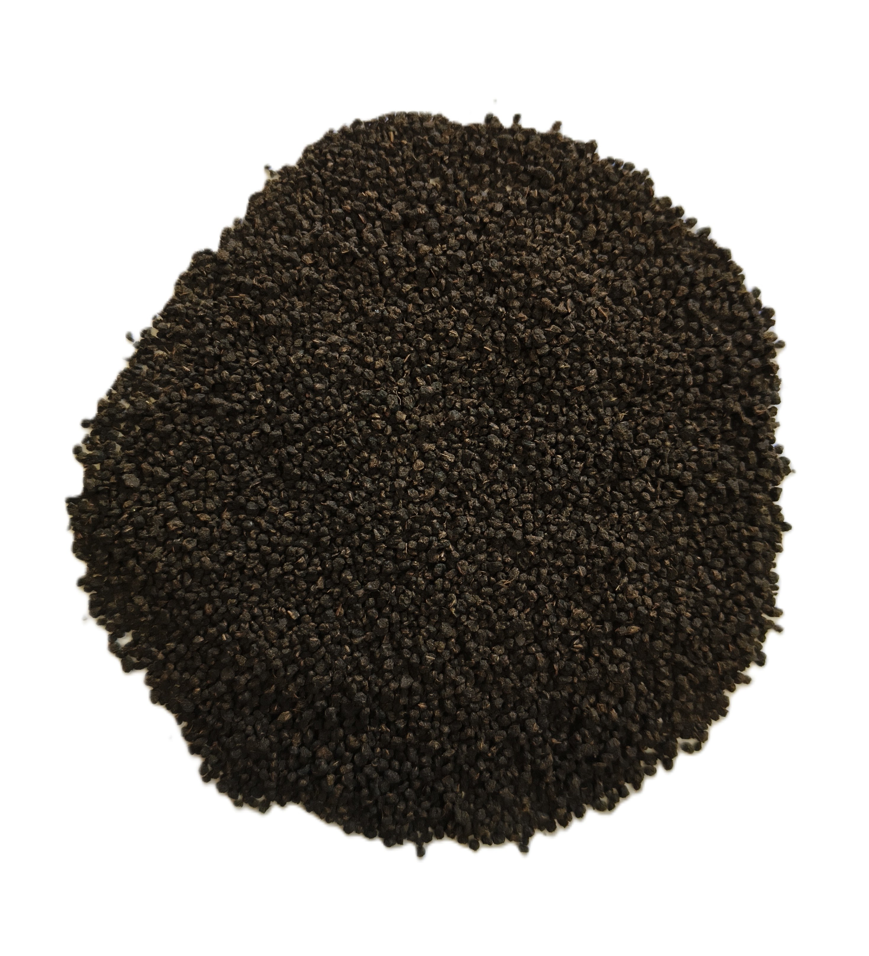 A pile of dark brown to black granular material, likely coffee grounds or seed pods, photographed from directly above on a solid white background.