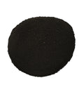 A circular pile of dark black granular powder or substrate material on a solid white background.