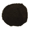 A pile of dark brown to black granular powder or substrate material, photographed from directly above on a plain white background.