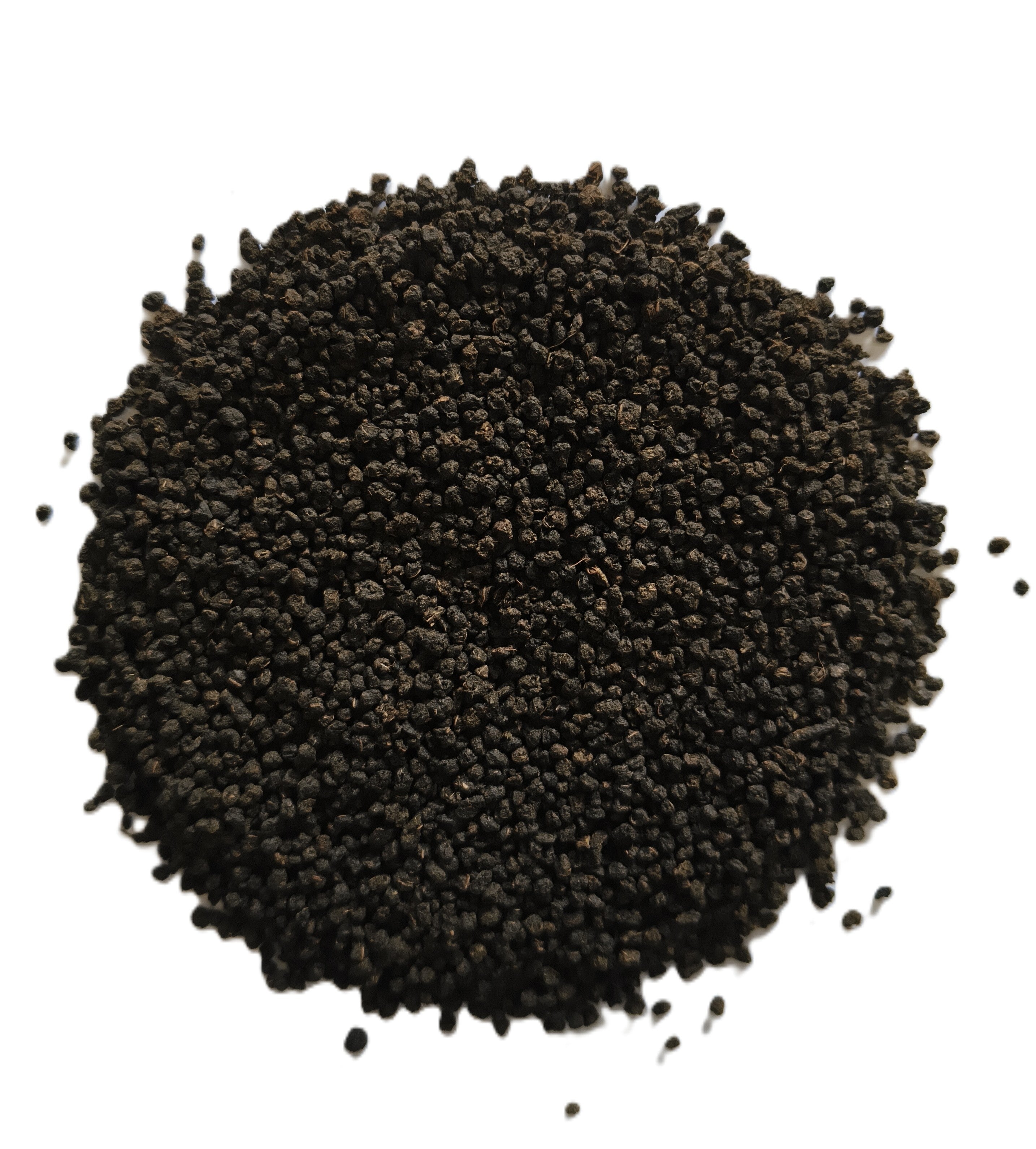 A pile of small dark brown to black seeds or granules photographed from above on a plain white background.