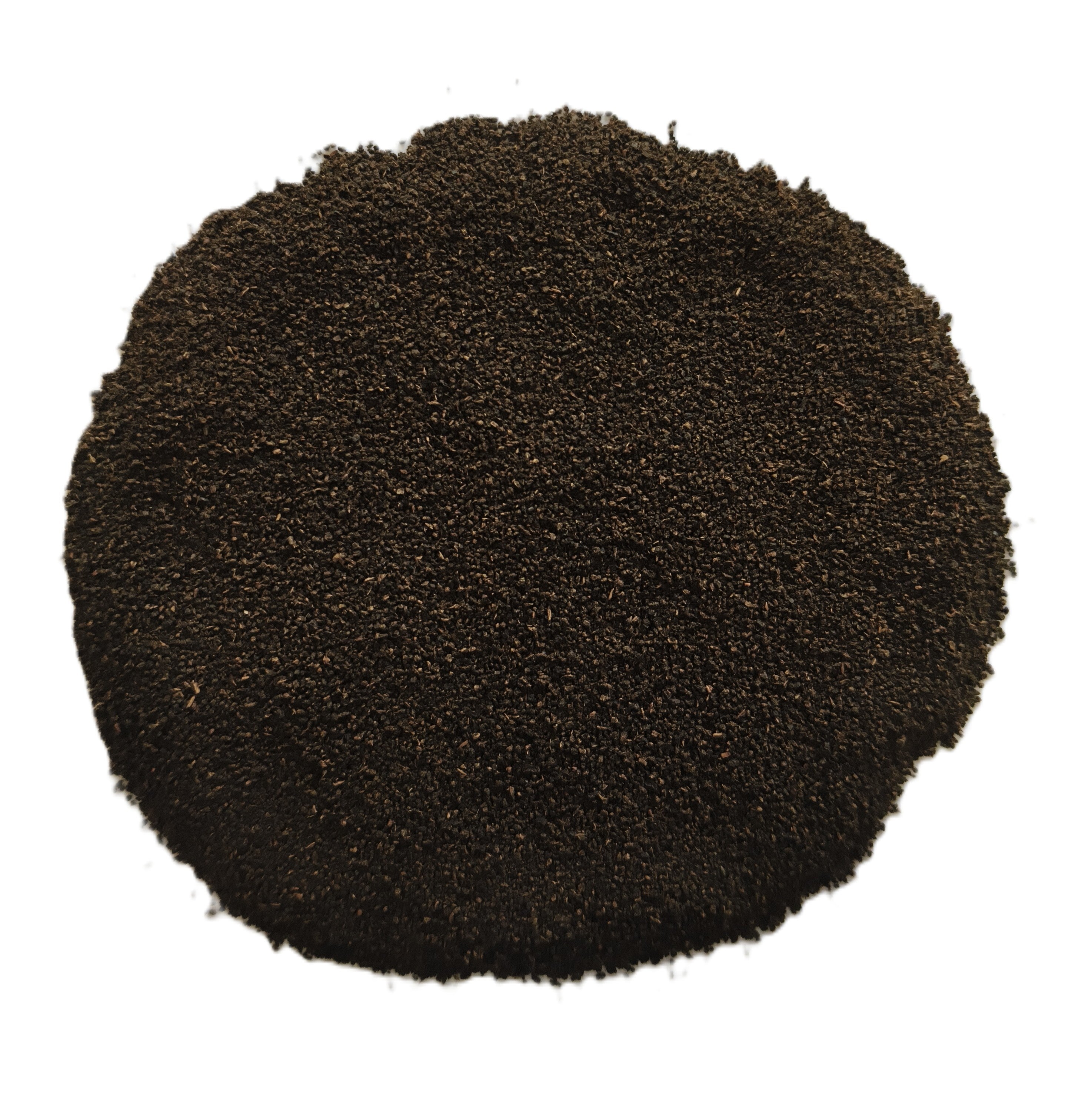 A circular pile of dark brown to black granular powder or substrate material, photographed from directly above on a plain white background.