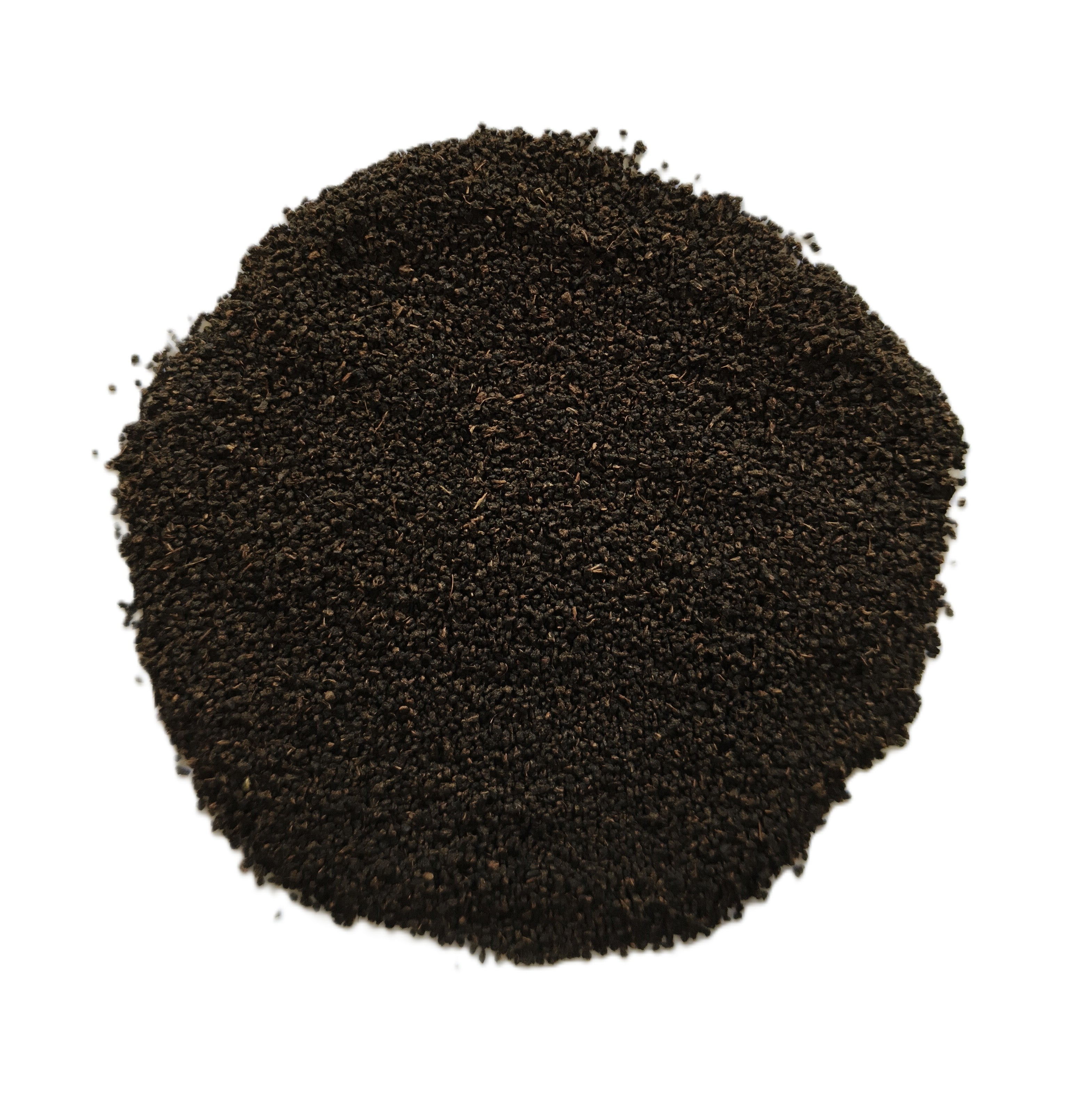 A pile of dark brown to black coarse sand or gravel, photographed from directly above on a solid white background.
