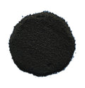 A pile of dark black granular powder or substrate material, photographed from directly above on a solid white background.